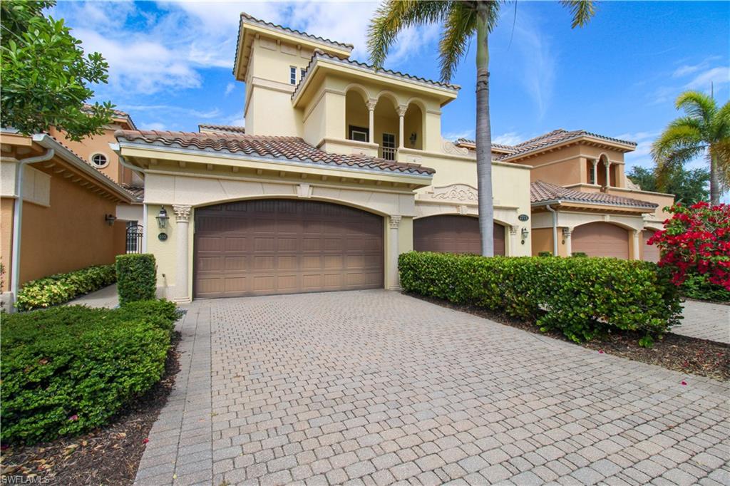 2713 Callista Court, Unit 103 Naples, FL 34114 - Photo 2 of 47 a front view of a house with a yard and garage