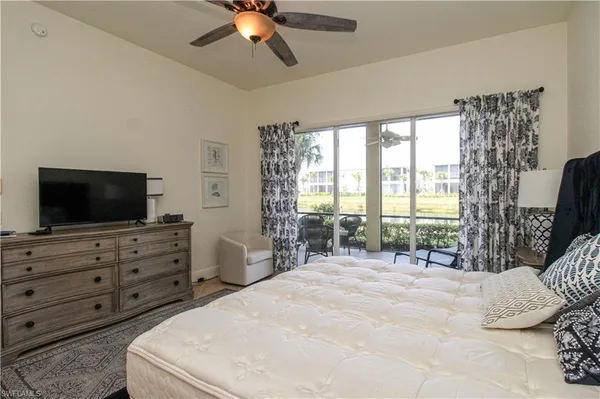 a bedroom with a bed and a television