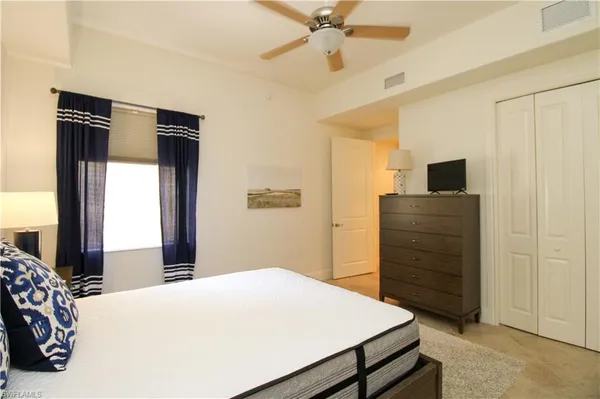 a bedroom with a bed and a dresser