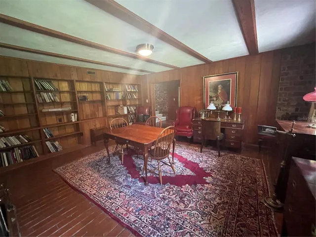 a living room with a rug table and chairs