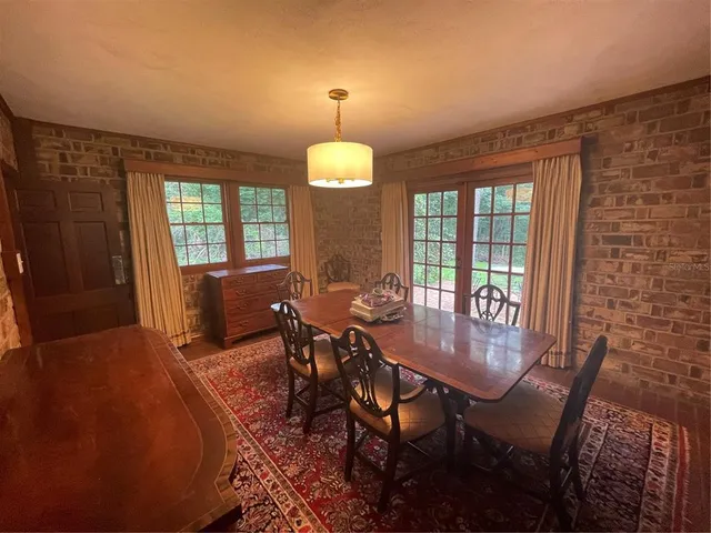 a view of a dining room with furniture and chandelier
