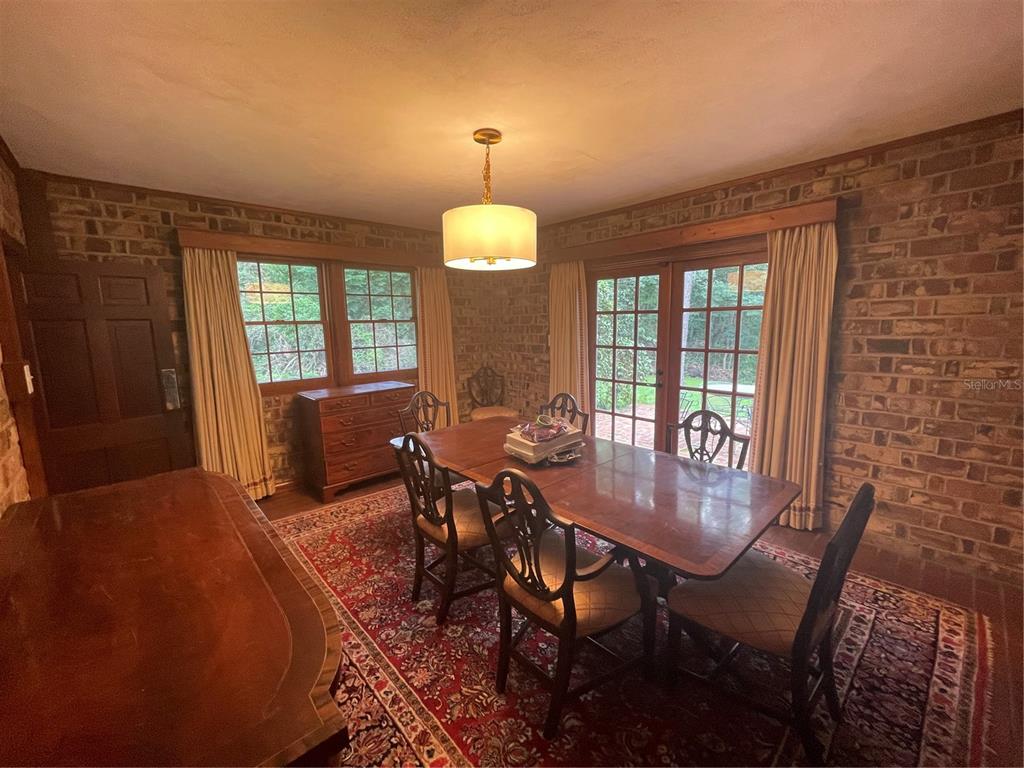 1801 Northwest 30th Terrace Gainesville, FL 32605 - Photo 15 of 36 a view of a dining room with furniture and chandelier