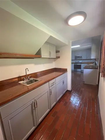 a kitchen with a sink and refrigerator