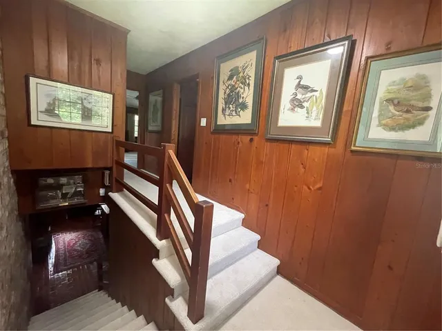 a view of an entryway with wooden floor and a workspace