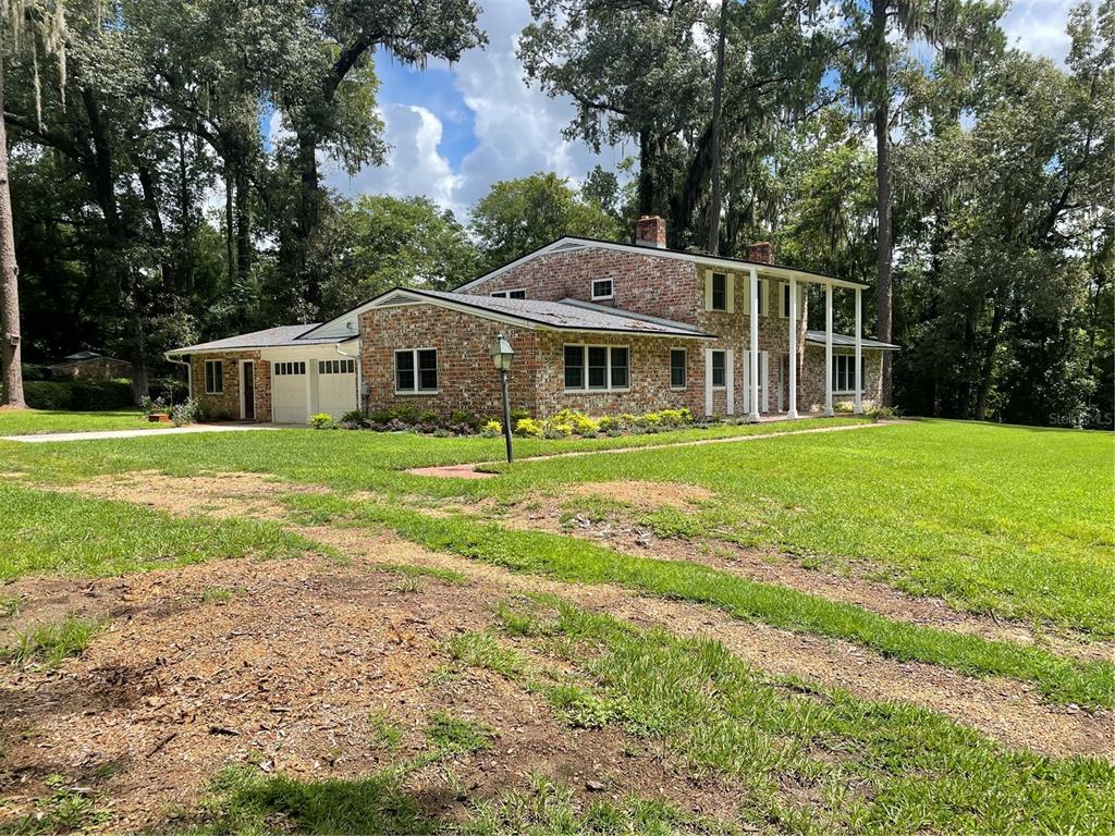 1801 Northwest 30th Terrace Gainesville, FL 32605 - Photo 2 of 36 a front view of a house with yard and green space