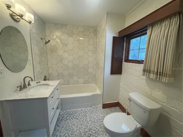 a bathroom with a sink a toilet and tub