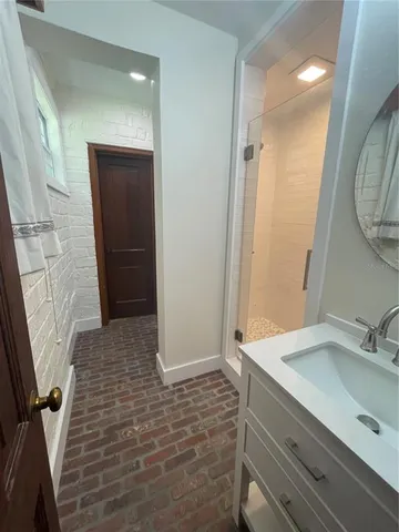 a bathroom with a sink a shower and a mirror