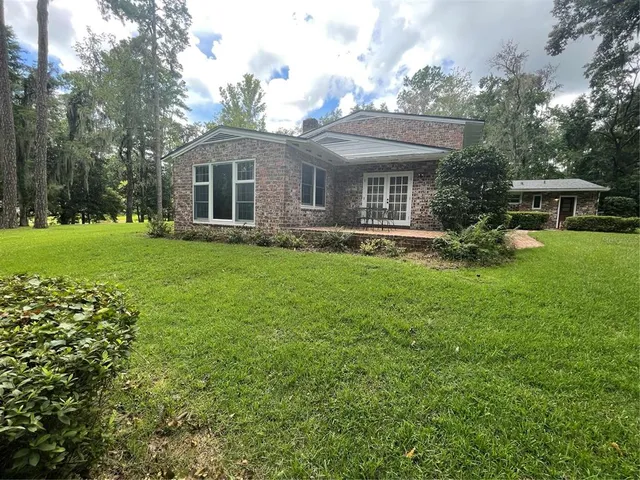 a front view of house with yard and green space
