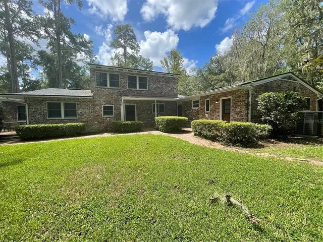 a house view with swimming pool and garden space