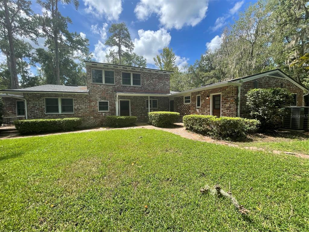 1801 Northwest 30th Terrace Gainesville, FL 32605 - Photo 32 of 36 a house view with swimming pool and garden space