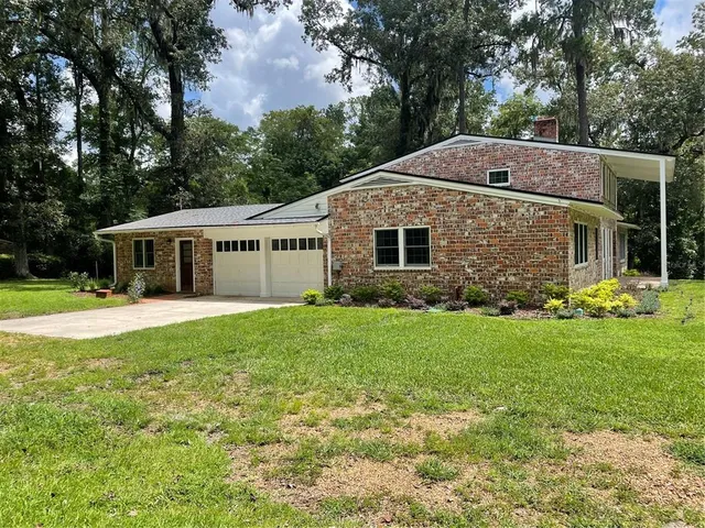 a front view of house with yard and green space