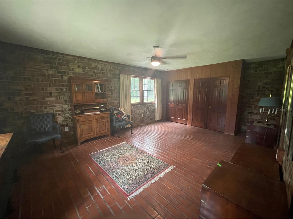 1801 Northwest 30th Terrace Gainesville, FL 32605 - Photo 6 of 36 a living room with stainless steel appliances furniture a rug and a kitchen view
