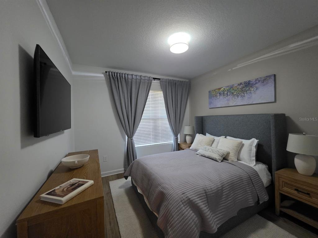 Undisclosed Address Reunion, FL 34747 - Photo 11 of 14 a bedroom with a bed and a flat screen tv