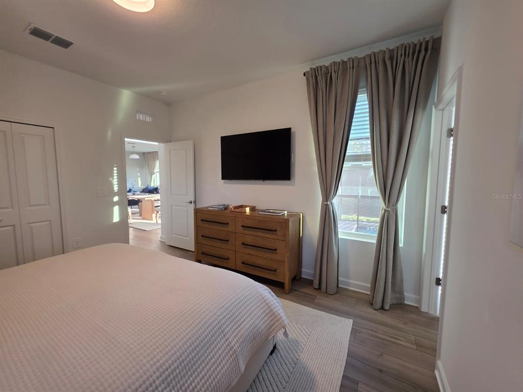 Undisclosed Address Reunion, FL 34747 - Photo 12 of 14 a bedroom with a bed and a flat screen tv