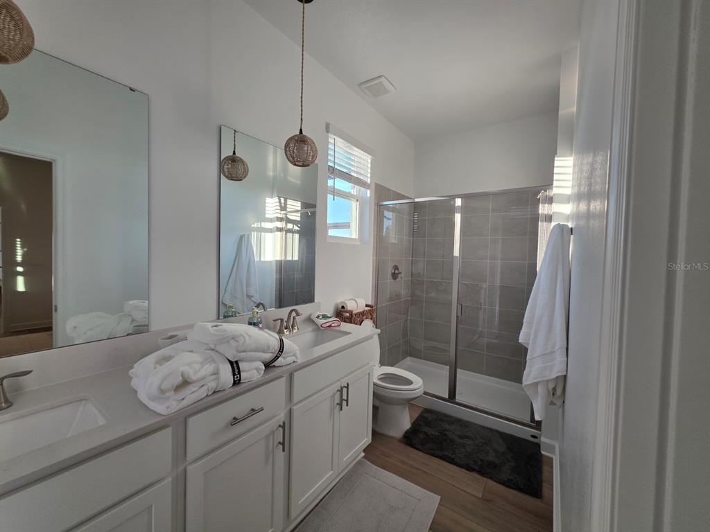 Undisclosed Address Reunion, FL 34747 - Photo 13 of 14 a spacious bathroom with sink shower and mirror