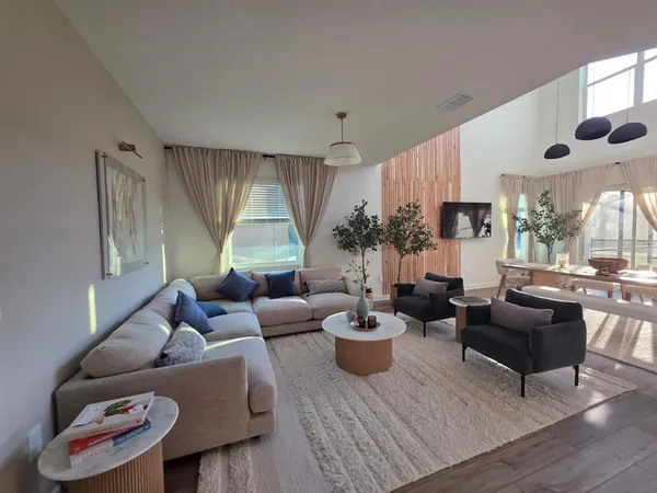 a living room with furniture and a large window