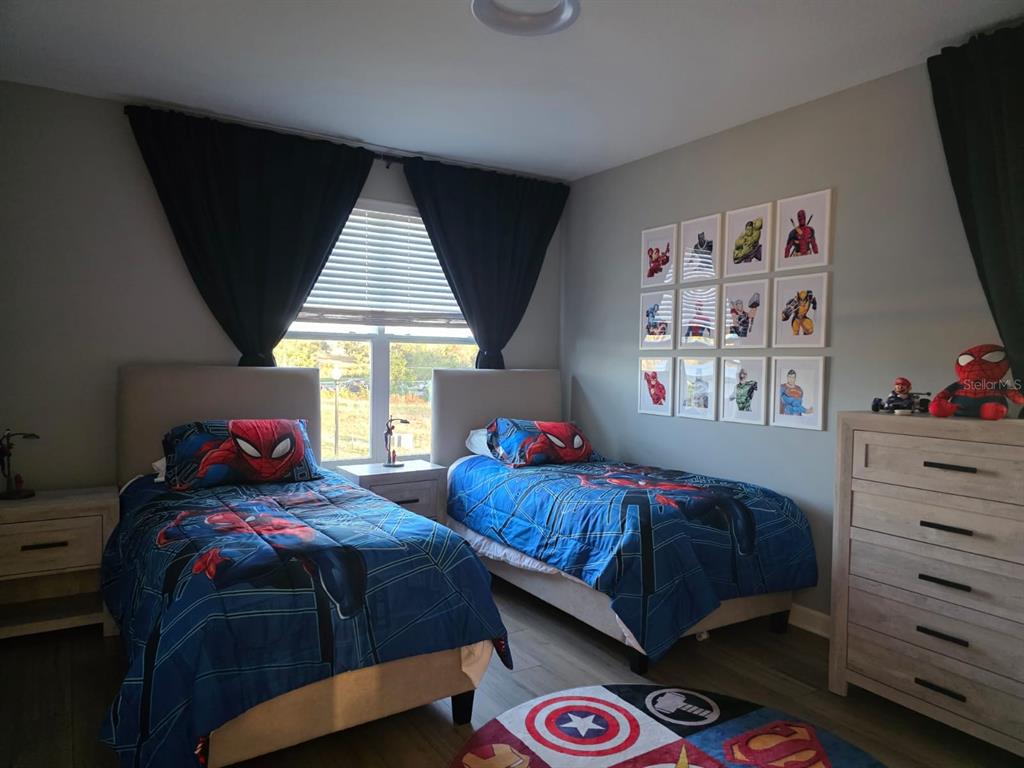 Undisclosed Address Reunion, FL 34747 - Photo 5 of 14 a bedroom with two beds and a window