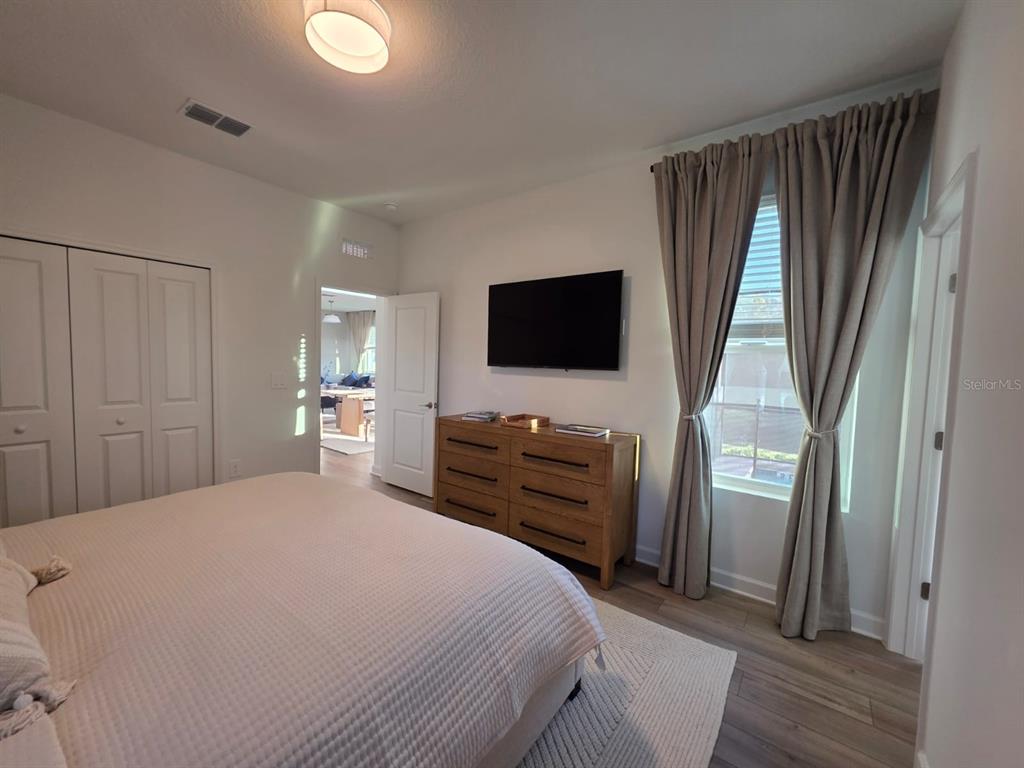 Undisclosed Address Reunion, FL 34747 - Photo 8 of 14 a bedroom with a bed and a flat screen tv