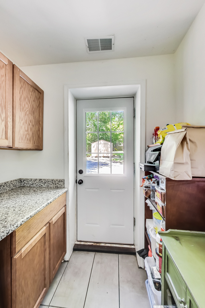 1518 Riverside Avenue St. Charles, IL 60174 - Photo 20 of 40 a utility room with fridge and wooden floor