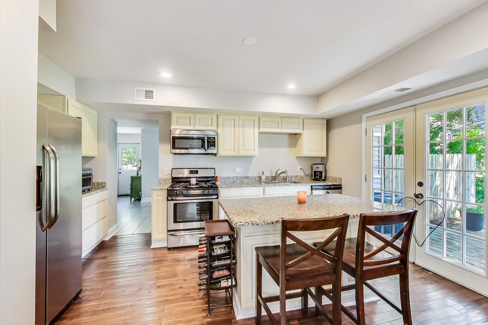 1518 Riverside Avenue St. Charles, IL 60174 - Photo 10 of 40 a kitchen with stainless steel appliances granite countertop a stove top oven a sink dishwasher a dining table and chairs with wooden floor