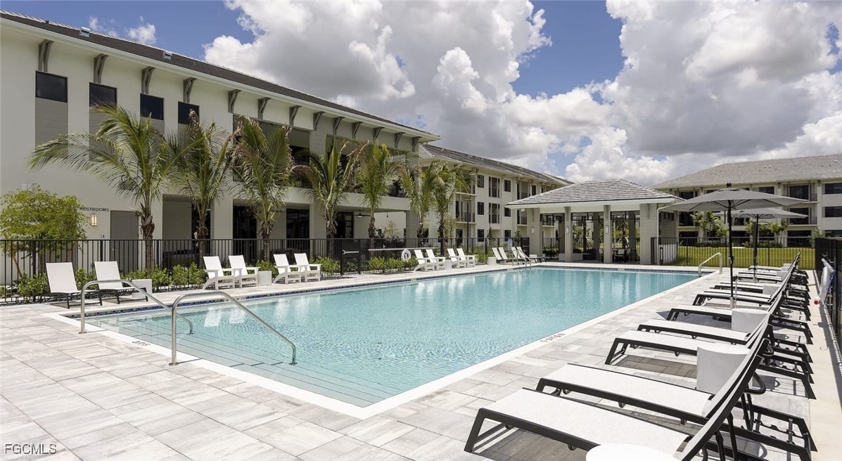 7301 Lake Bank Loop, Unit AMITY Fort Myers, FL 33966 - Photo 1 of 27 a view of a swimming pool with a patio
