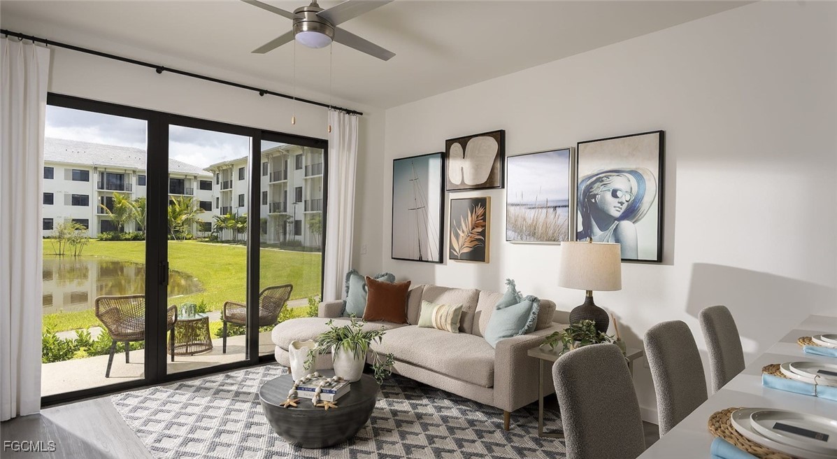 7301 Lake Bank Loop, Unit AMITY Fort Myers, FL 33966 - Photo 20 of 27 a living room with furniture and a floor to ceiling window