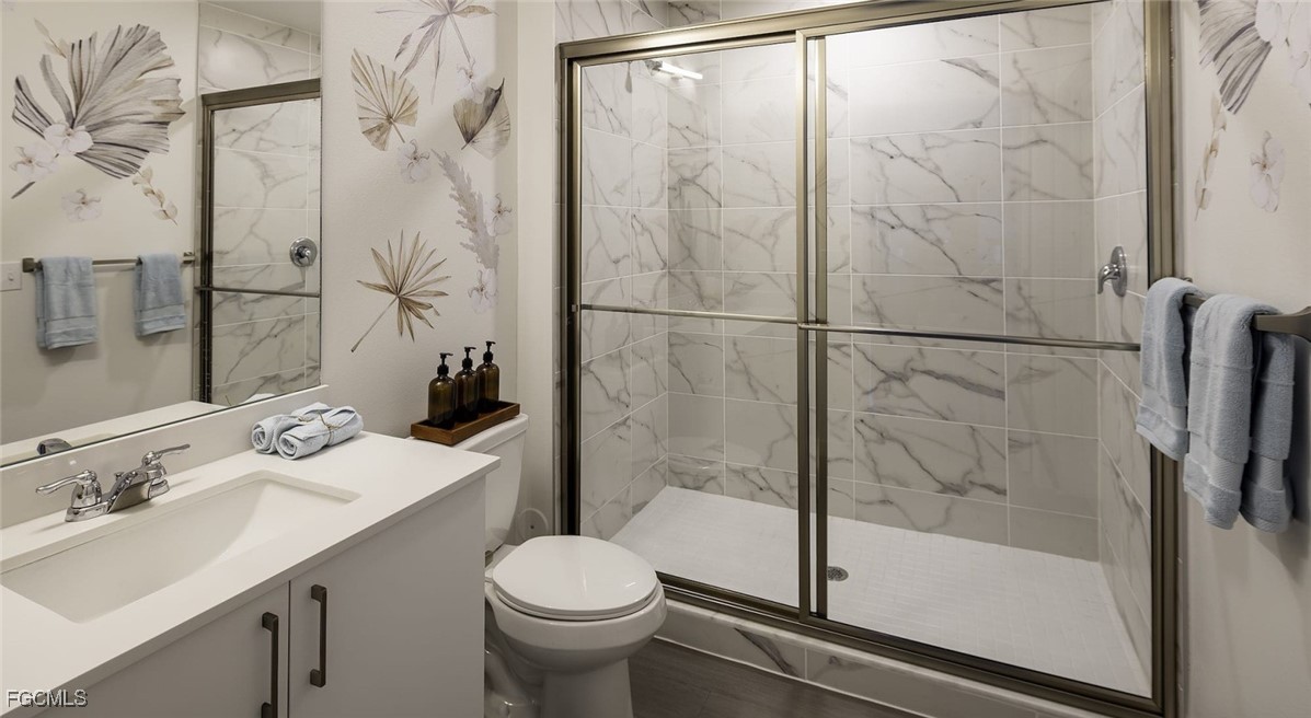 7301 Lake Bank Loop, Unit AMITY Fort Myers, FL 33966 - Photo 25 of 27 a bathroom with a sink toilet and shower