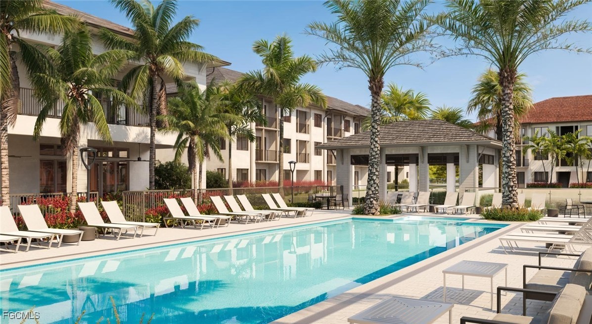 7301 Lake Bank Loop, Unit AMITY Fort Myers, FL 33966 - Photo 3 of 27 a view of a swimming pool with a patio