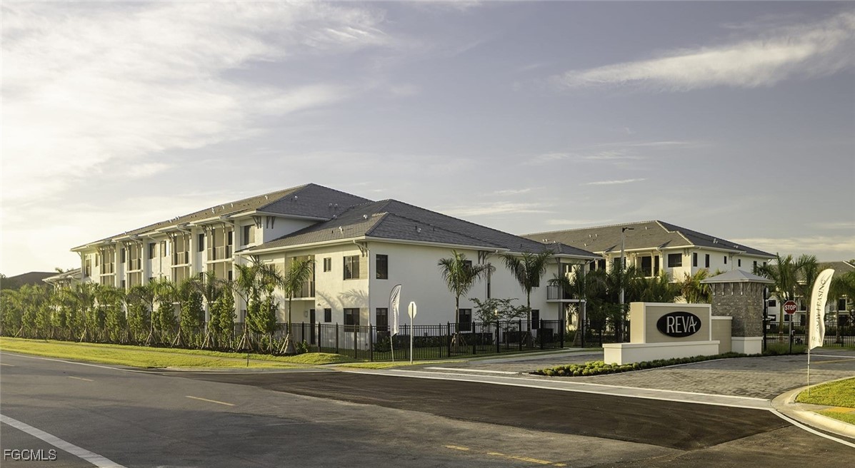 7301 Lake Bank Loop, Unit AMITY Fort Myers, FL 33966 - Photo 4 of 27 a front view of a house with a yard
