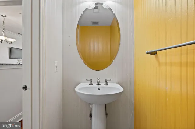 a bathroom with a sink and mirror