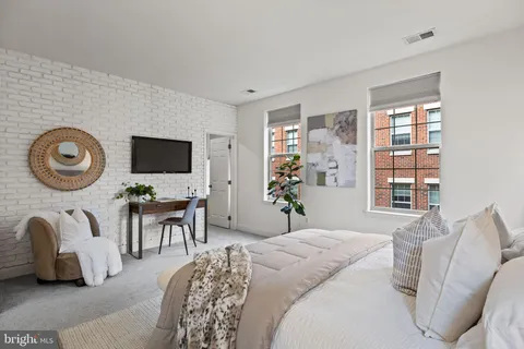 a bedroom with bed and a flat tv screen