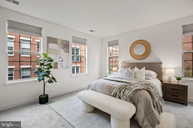 a bedroom with a bed and a potted plant