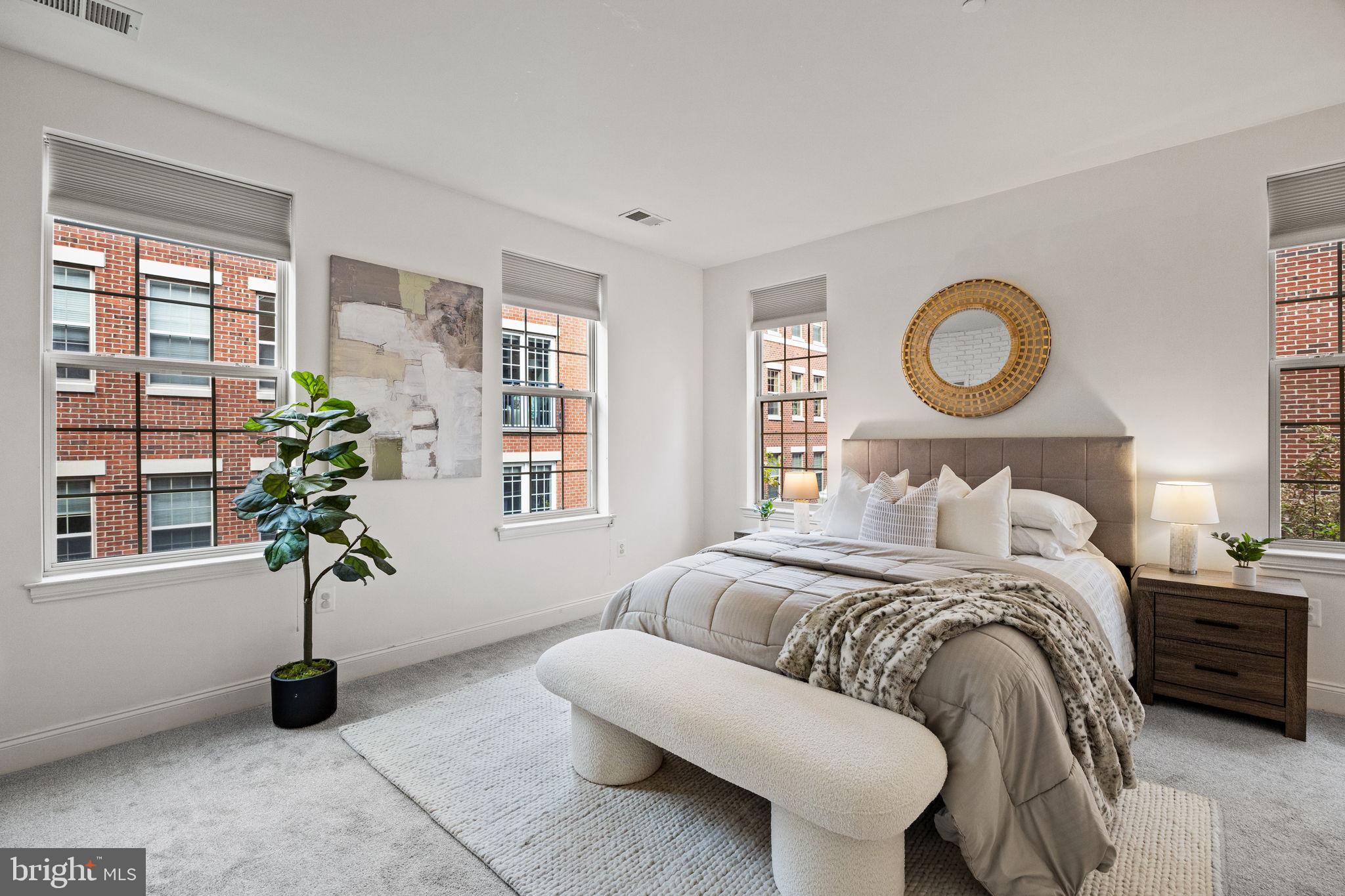 201 Commodore Court Philadelphia, PA 19146 - Photo 19 of 61 a bedroom with a bed and a potted plant