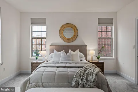 a bedroom with a large bed and a window