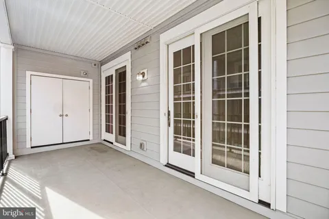 a view of a hallway with wooden floor and entryway