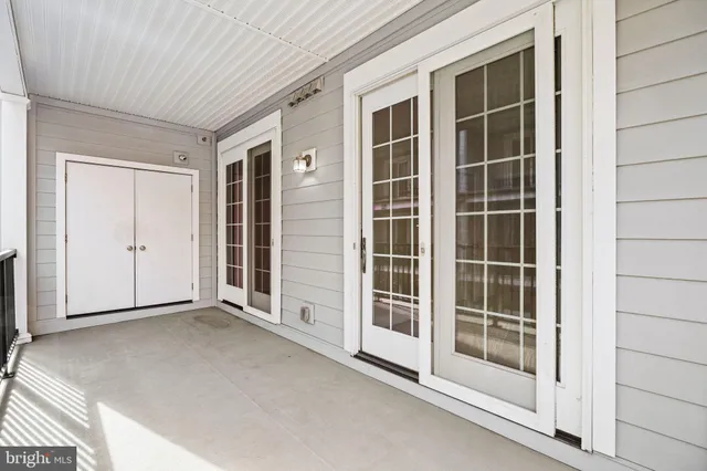 a view of a hallway with wooden floor and entryway