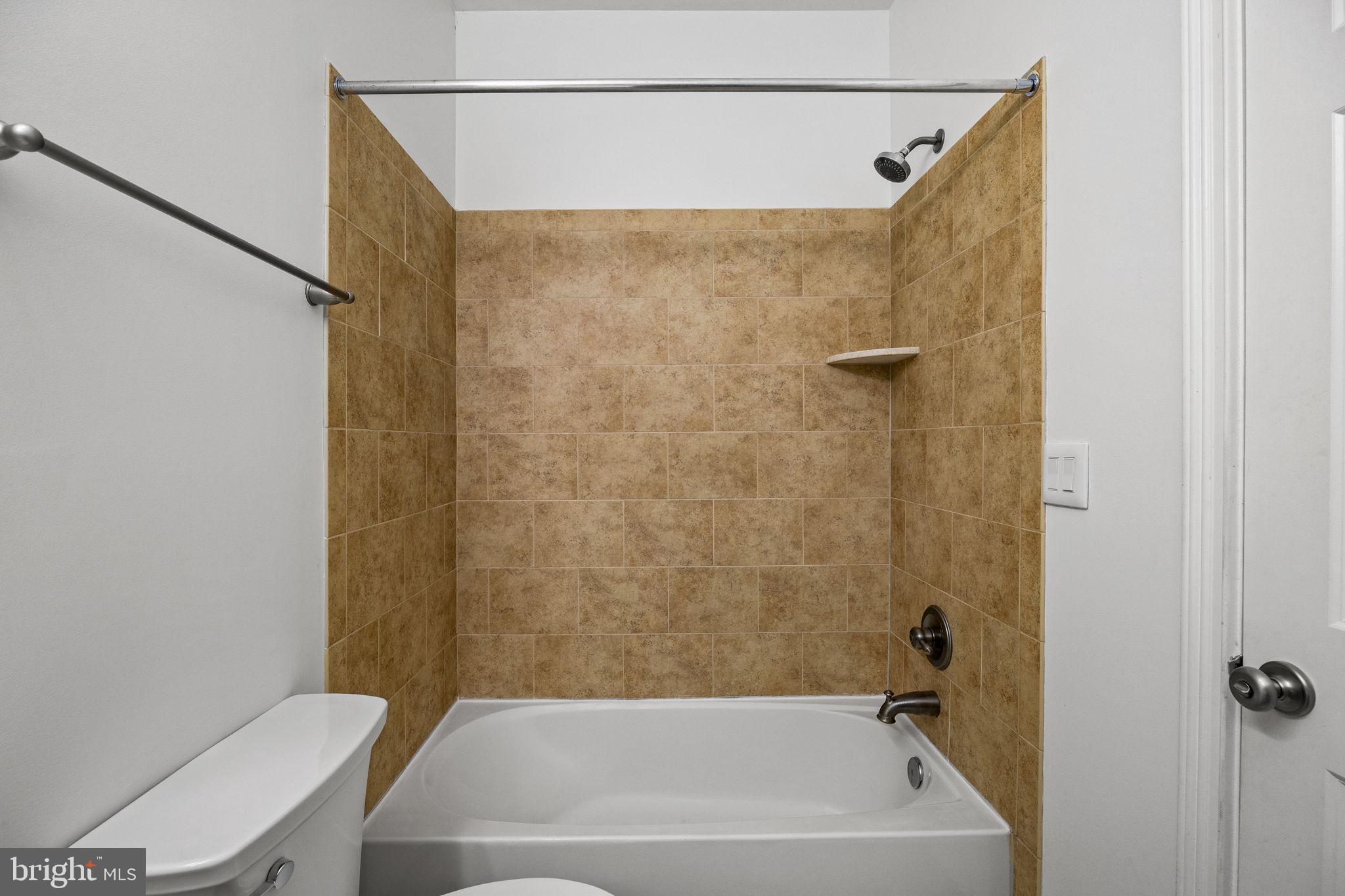 201 Commodore Court Philadelphia, PA 19146 - Photo 41 of 61 a bathroom with a bathtub and a shower