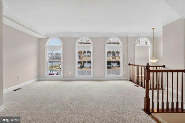 a kitchen with stainless steel appliances granite countertop a stove top oven a sink dishwasher and a refrigerator with wooden floor