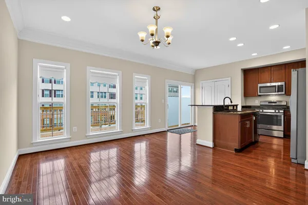 a kitchen with stainless steel appliances granite countertop a stove a microwave and a refrigerator