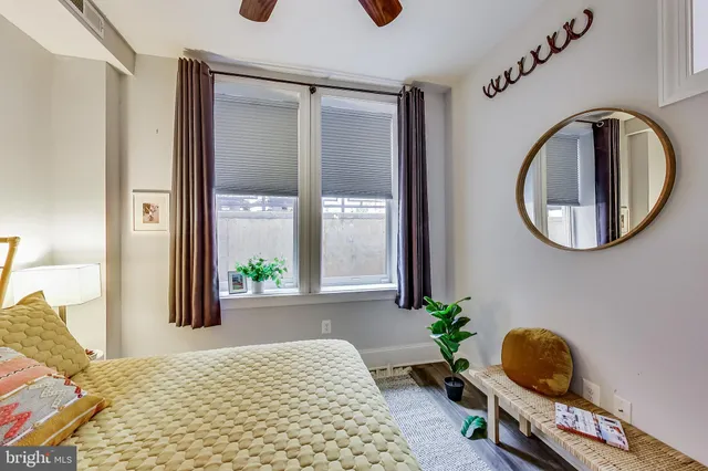 a bedroom with a bed and a mirror