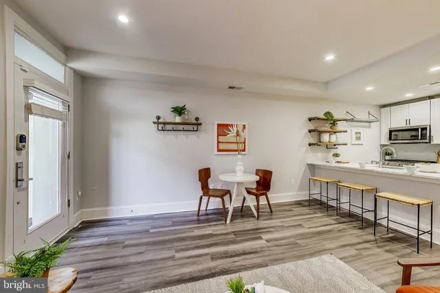 a view of kitchen with cabinets table and chairs