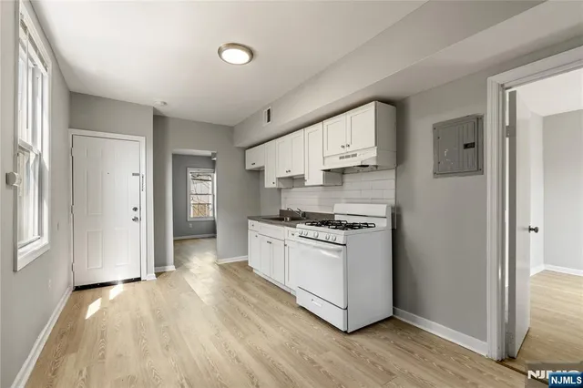 a kitchen with stainless steel appliances granite countertop a stove and a refrigerator