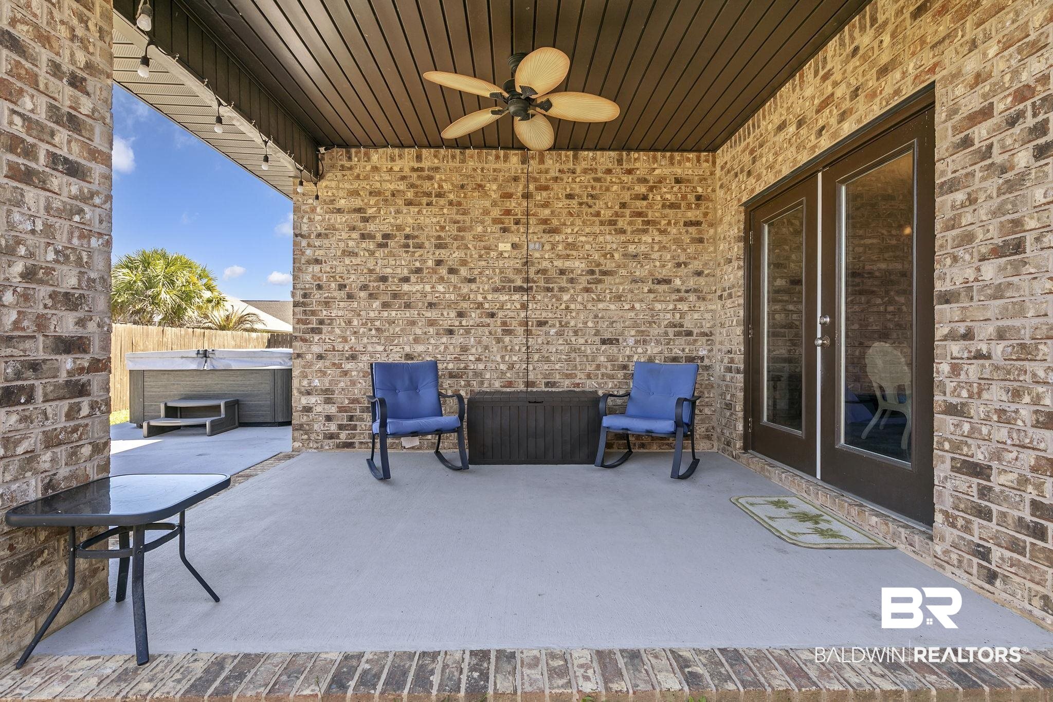 1547 Kairos Loop Foley, AL 36535 - Photo 42 of 55 View of patio / terrace with a ceiling fan, fence, and a hot tub