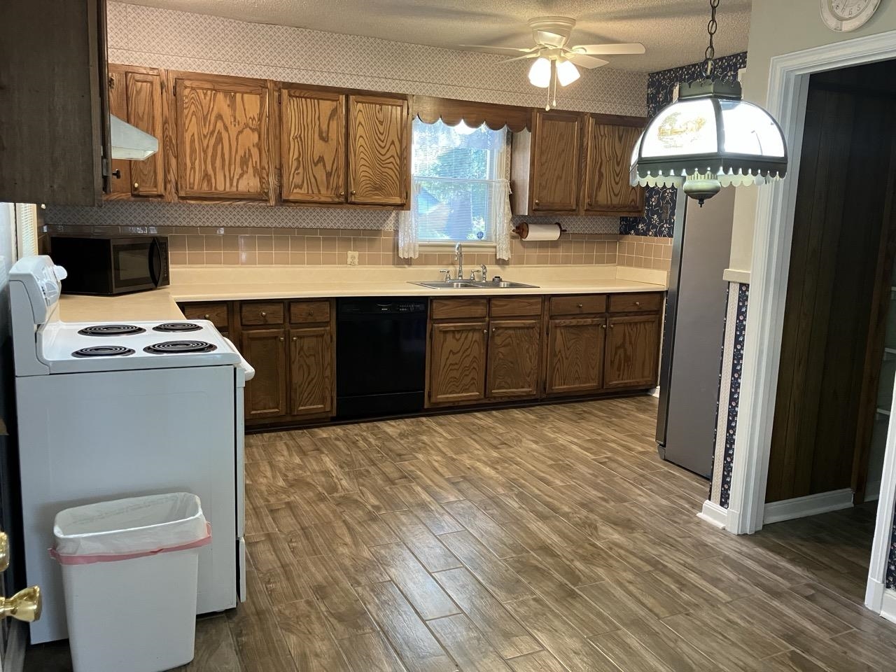 3706 Rhea Avenue Memphis, TN 38122 - Photo 6 of 21 a kitchen with stainless steel appliances a sink a stove a refrigerator cabinets and wooden floor