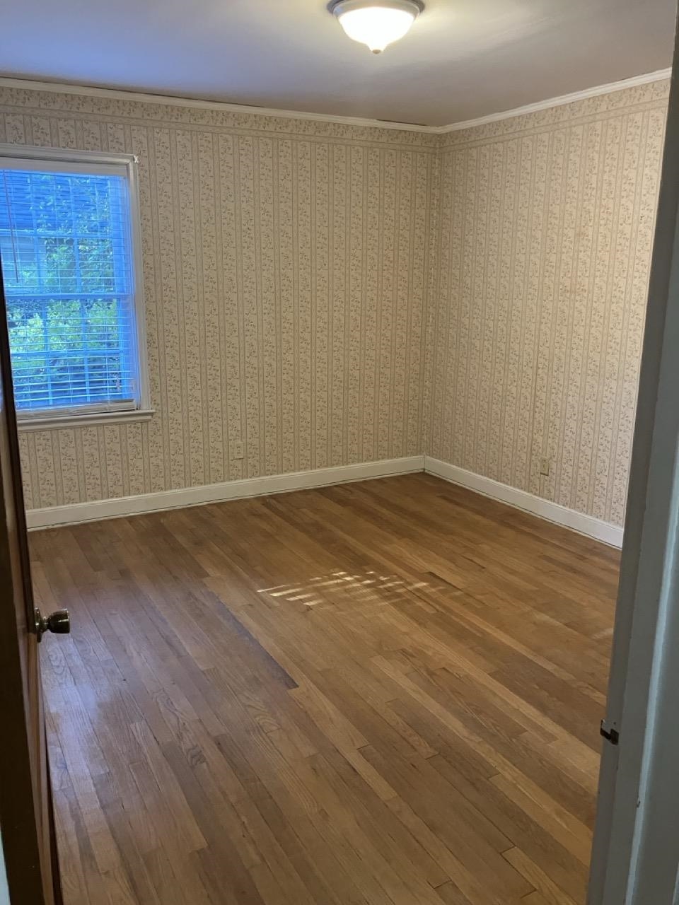3706 Rhea Avenue Memphis, TN 38122 - Photo 10 of 21 a view of a room with wooden floor and brick walls