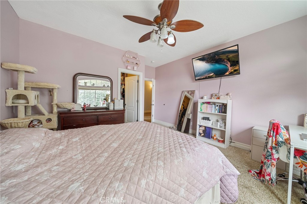 7172 Jargon Road Hesperia, CA 92344 - Photo 34 of 75 a bedroom with a bed and a flat screen tv