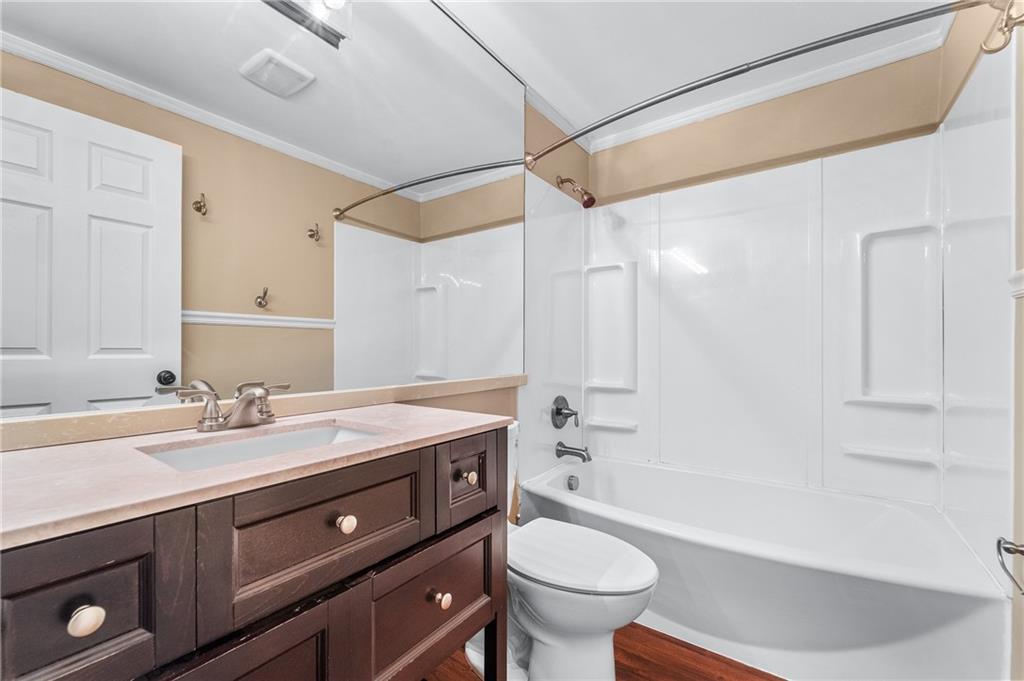 310 Ridge Point Circle Bridgeville, PA 15017 - Photo 14 of 20 a bathroom with a sink a toilet a mirror a bathtub and shower