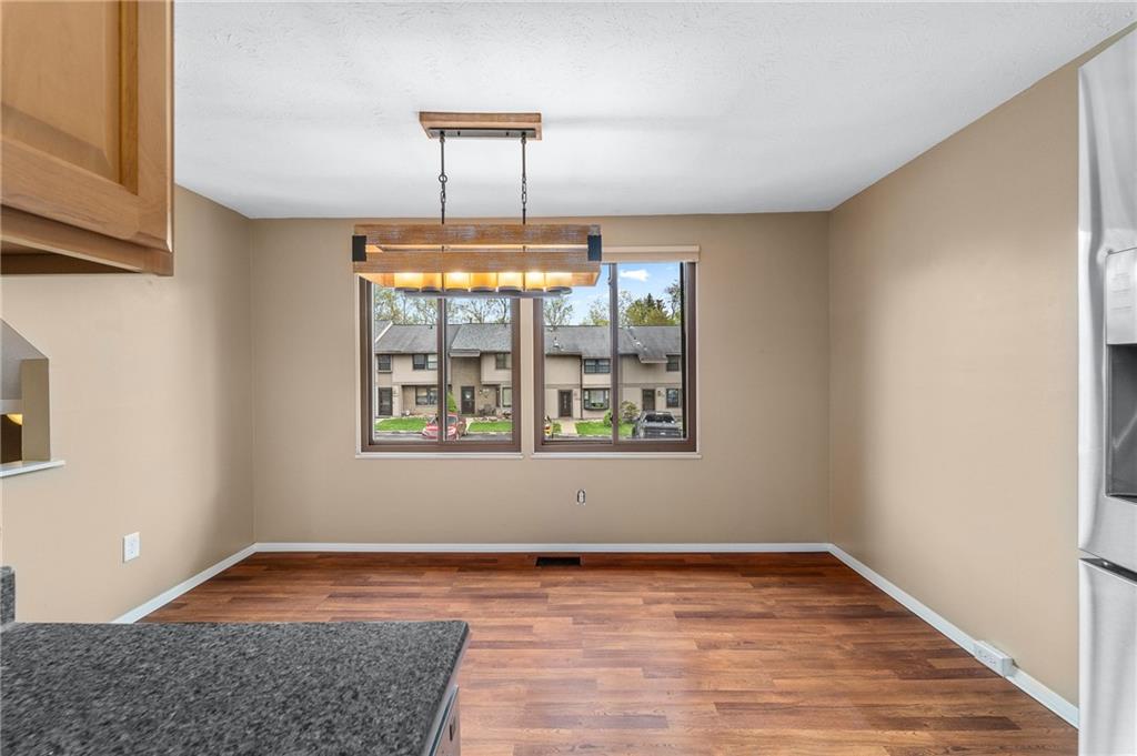 310 Ridge Point Circle Bridgeville, PA 15017 - Photo 5 of 20 a view of an empty room with window and wooden floor