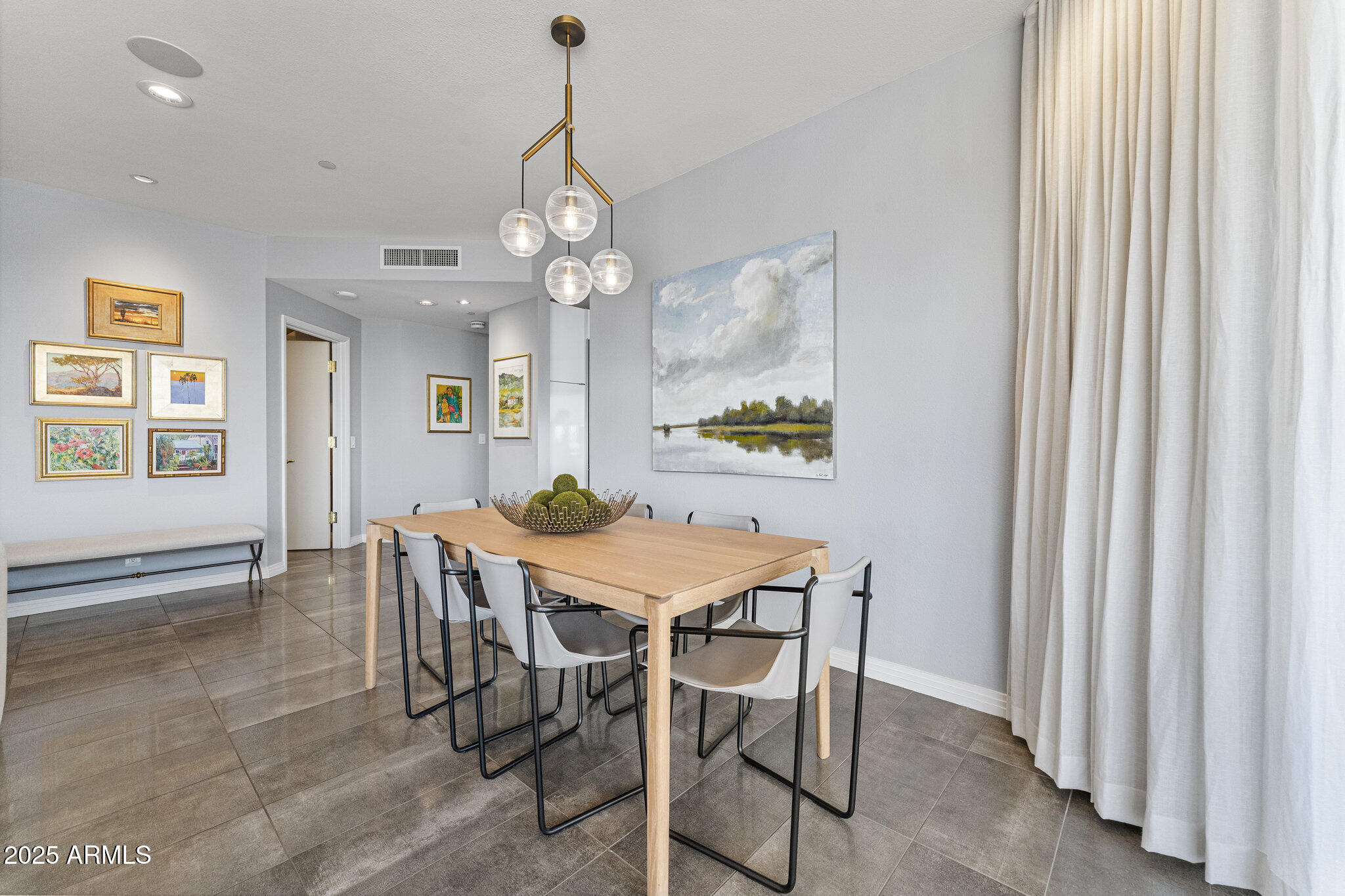 1040 East Osborn Road, Unit 1103 Phoenix, AZ 85014 - Photo 20 of 49 a view of a dining room with furniture and chandelier