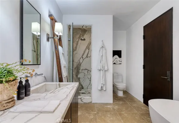 a bathroom with a tub sink and a mirror